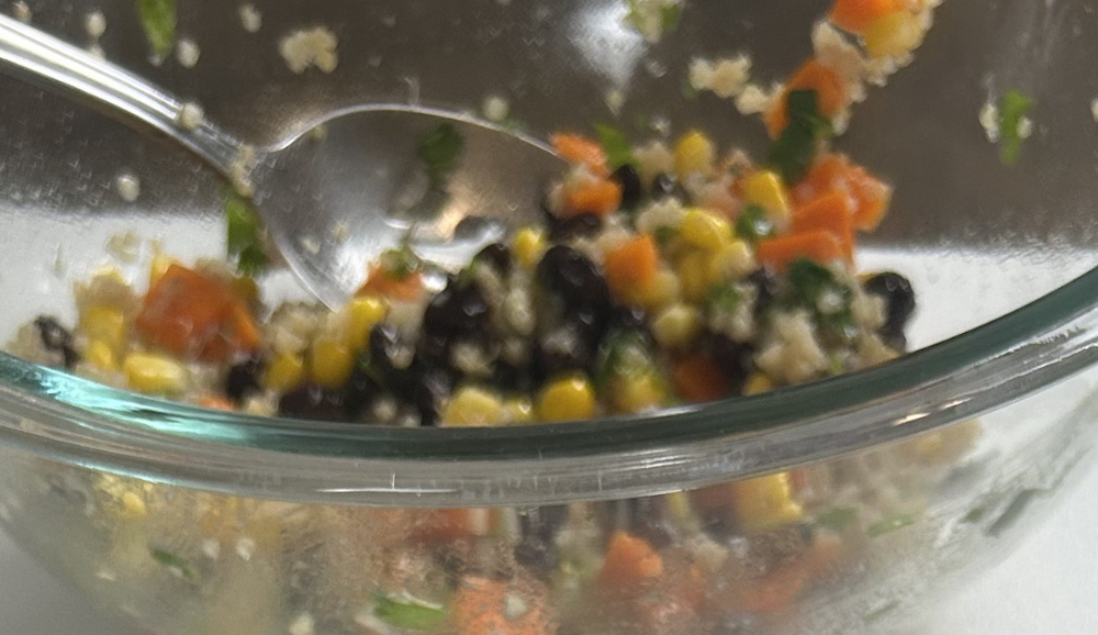 Quinoa and black bean salad in a mixing bowl