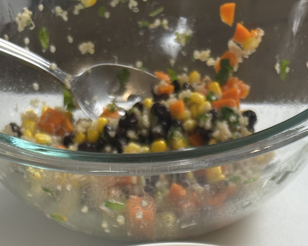 Quinoa and black bean salad in a mixing bowl