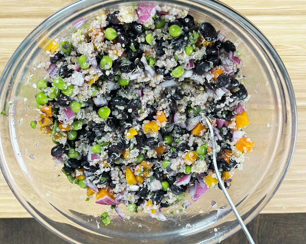 Quinoa,black bean and Green pea salad ingredients mixture in a bowl