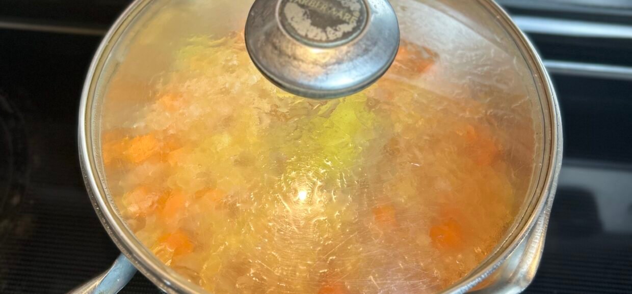 Chickpea curry with sweet potato sommering in a covered pot