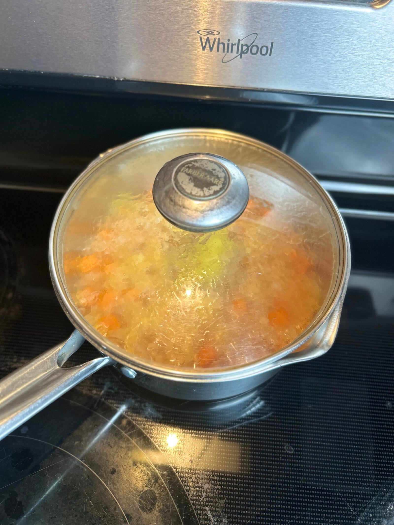 Chickpea curry with sweet potato sommering in a covered pot