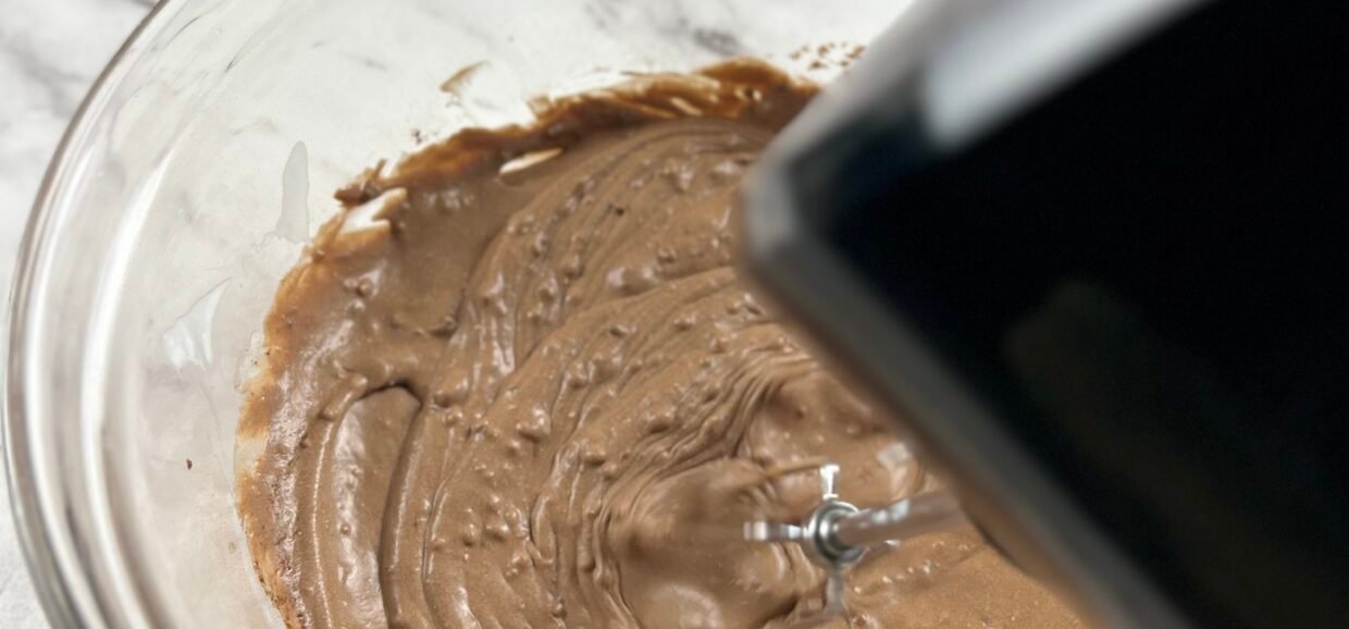 Carob mousse preparation - sip in carob powder and whip smooth