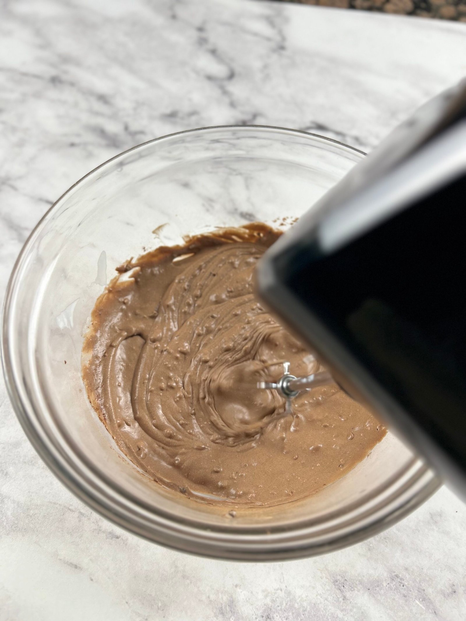 Carob mousse preparation - sip in carob powder and whip smooth